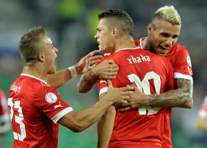 Xhaka of Switzerland celebrates scoring a goal with team mates Shaqiri and Behrami during their World Cup 2014 qualifying soccer match against Slovenia in Ljubljana